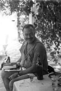 EH 4449P Ernest Hemingway reading books with his dog Negrita at Finca Vigia in Cuba. Please credit "Ernest Hemingway Collection/John F. Kennedy Presidential Library and Museum, Boston"